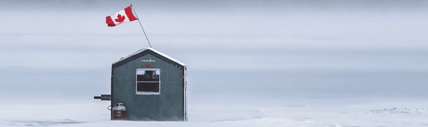 An ice fishing hut on Pigeon Lake stands firm in gusting snow and wind